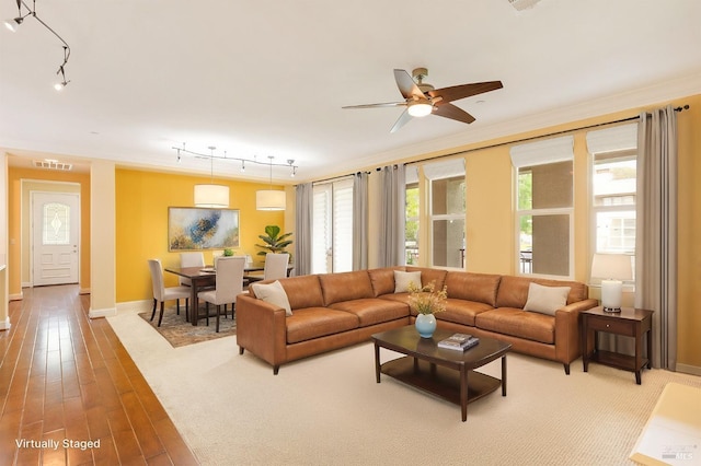 living room with visible vents, ornamental molding, baseboards, ceiling fan, and rail lighting