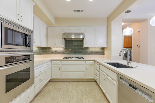 kitchen featuring visible vents, range hood, a sink, light countertops, and stainless steel appliances