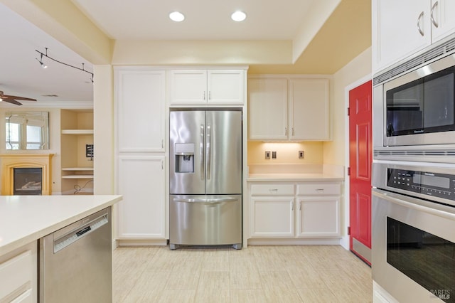 kitchen with light countertops, stainless steel appliances, a ceiling fan, and white cabinetry