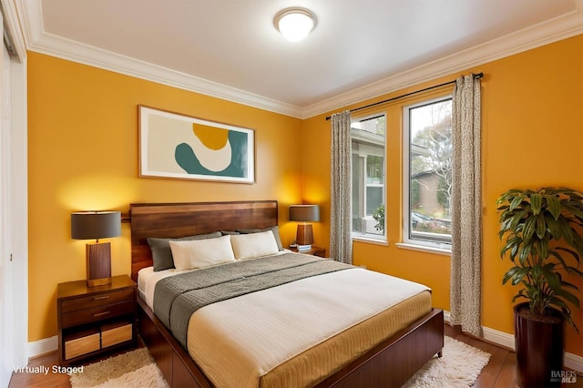 bedroom with crown molding, baseboards, multiple windows, and wood finished floors