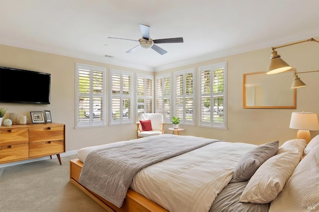 bedroom featuring crown molding, a ceiling fan, and carpet floors