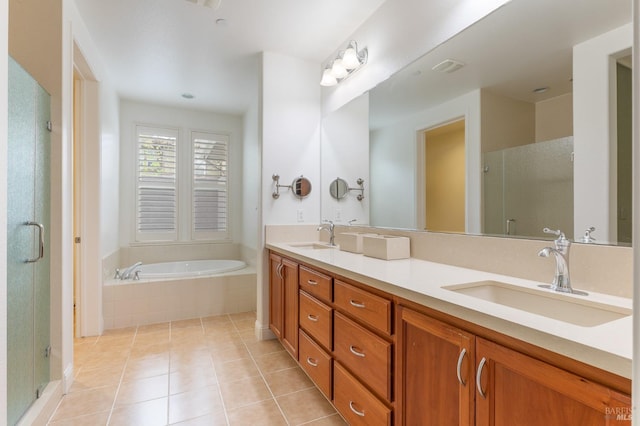 full bath featuring a garden tub, a sink, tile patterned floors, and a shower stall