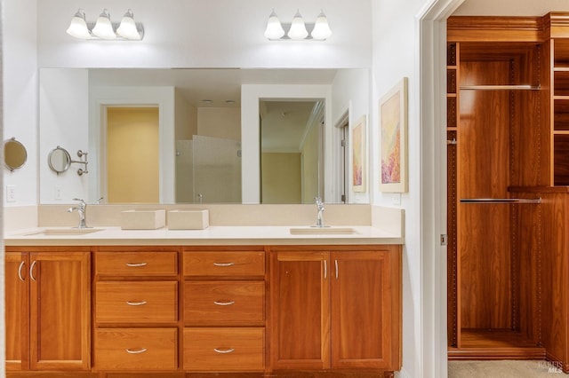 bathroom with double vanity, a sink, and a shower with door