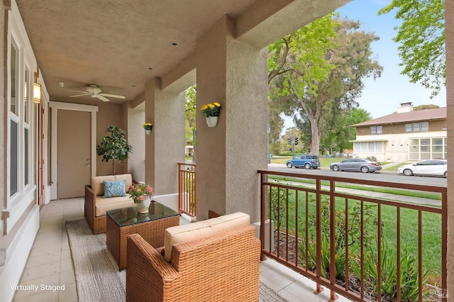 balcony featuring a porch and ceiling fan