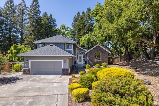 view of front of home with fence, an attached garage, concrete driveway, and brick siding