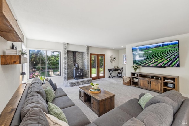 living area featuring a wood stove, carpet floors, french doors, recessed lighting, and baseboards