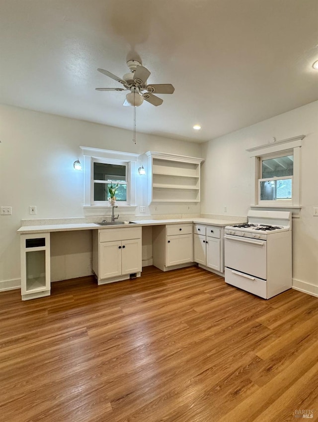 2984 First St, Napa, CA 94558 - kitchen with gas range gas stove, a sink, white cabinetry, light wood finished floors, and open shelves