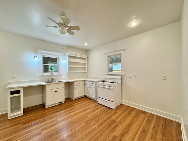 2984 First St, Napa, CA 94558 - kitchen with white range with gas cooktop, a sink, open shelves, light wood finished floors, and white cabinets