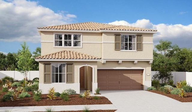 mediterranean / spanish house with a tiled roof, fence, concrete driveway, an attached garage, and stucco siding