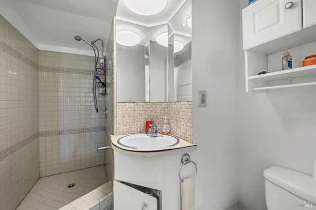 full bath with vanity, toilet, tile walls, tasteful backsplash, and a shower stall