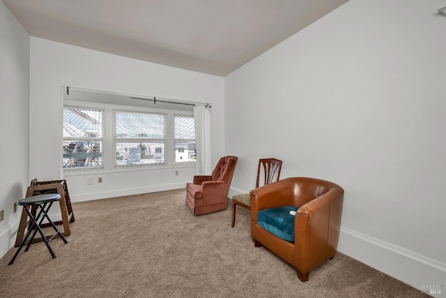 sitting room featuring carpet floors and baseboards