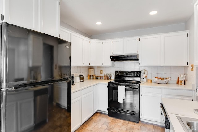 1034 Caldwell Ave, Vallejo, CA 94591 - kitchen with under cabinet range hood, white cabinets, black appliances, and light countertops