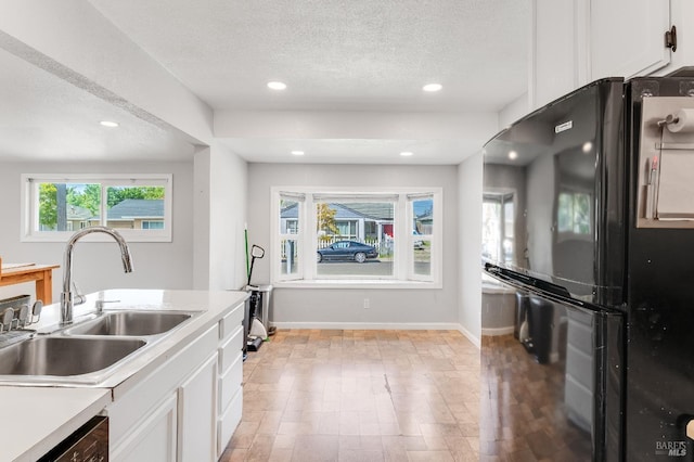 1034 Caldwell Ave, Vallejo, CA 94591 - kitchen with a textured ceiling, a sink, baseboards, white cabinets, and freestanding refrigerator
