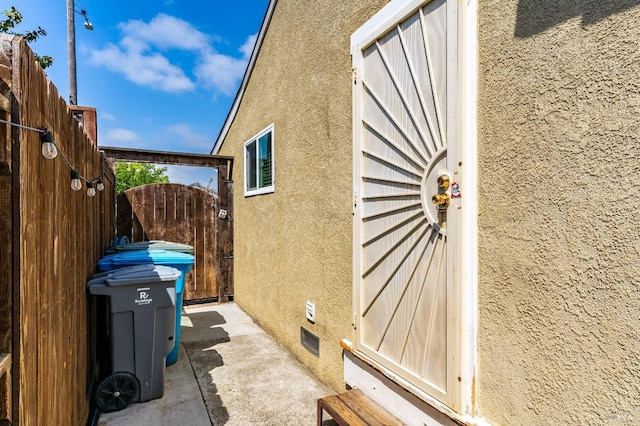 1034 Caldwell Ave, Vallejo, CA 94591 - view of property exterior with a gate, stucco siding, and crawl space