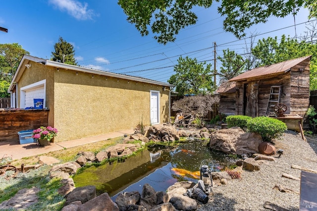 1034 Caldwell Ave, Vallejo, CA 94591 - view of yard with a garden pond and an outbuilding