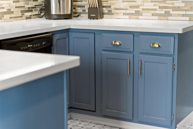 room details with blue cabinets, decorative backsplash, and light countertops