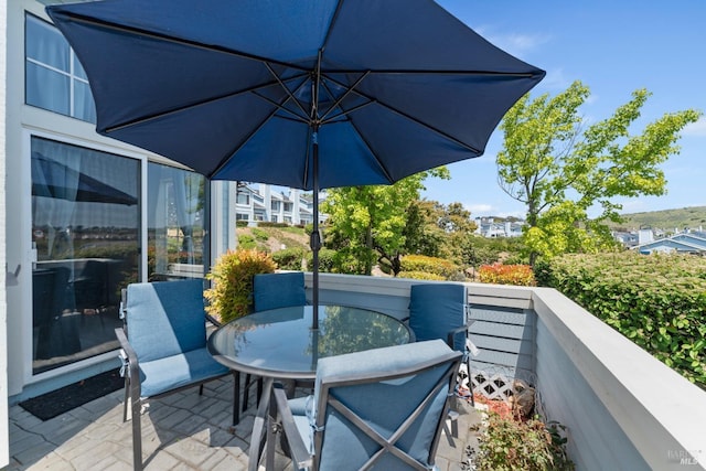 balcony with a patio and outdoor dining area