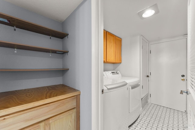 laundry area featuring cabinet space and washer and clothes dryer