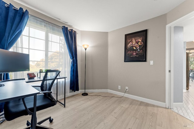 office area featuring baseboards and wood finished floors