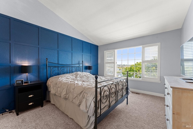 bedroom featuring light colored carpet, baseboards, vaulted ceiling, and visible vents
