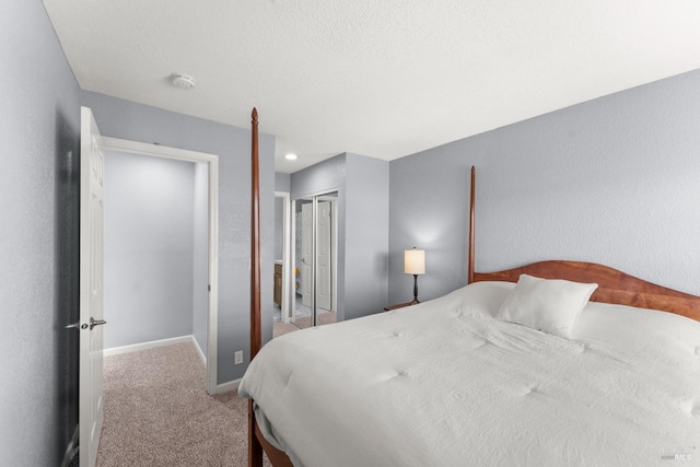carpeted bedroom featuring a closet and baseboards