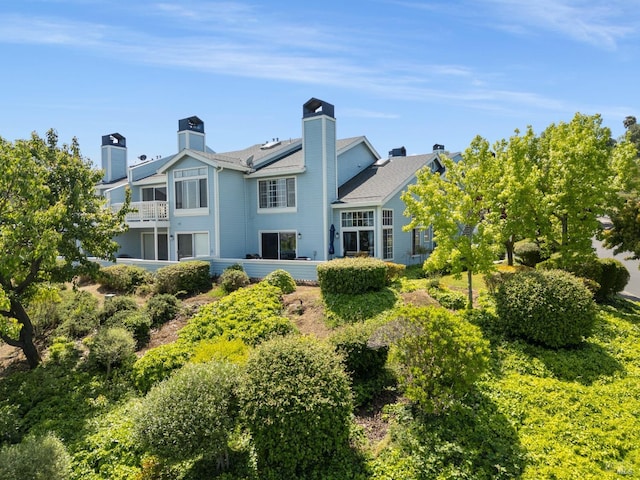 back of property featuring a chimney