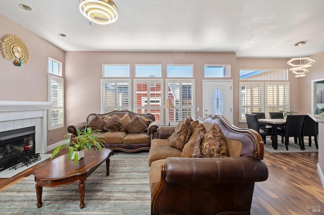 1216 Hermitage Way, Rohnert Park, CA 94928 - living room featuring a tiled fireplace, wood finished floors, and a notable chandelier