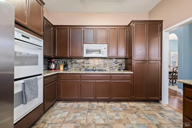 1216 Hermitage Way, Rohnert Park, CA 94928 - kitchen featuring appliances with stainless steel finishes, backsplash, stone finish flooring, and light stone counters