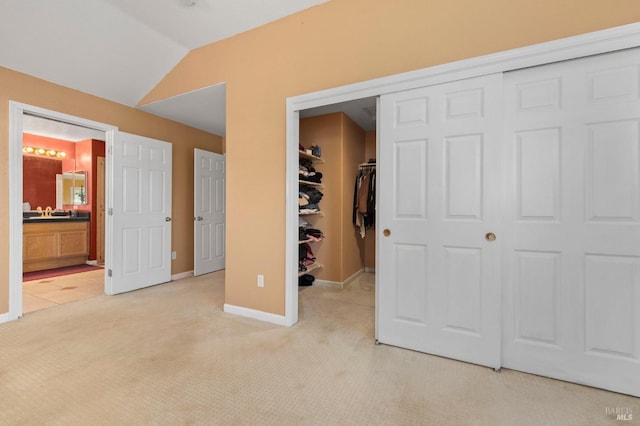 1216 Hermitage Way, Rohnert Park, CA 94928 - unfurnished bedroom featuring a closet, light carpet, baseboards, ensuite bathroom, and vaulted ceiling
