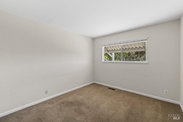 carpeted empty room with baseboards and visible vents