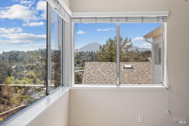 unfurnished sunroom with a mountain view