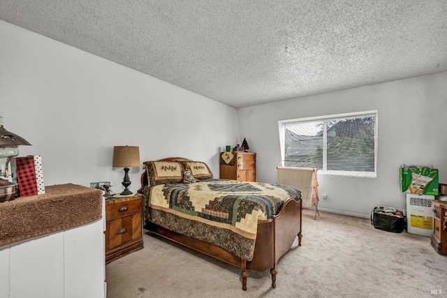 carpeted bedroom featuring a textured ceiling