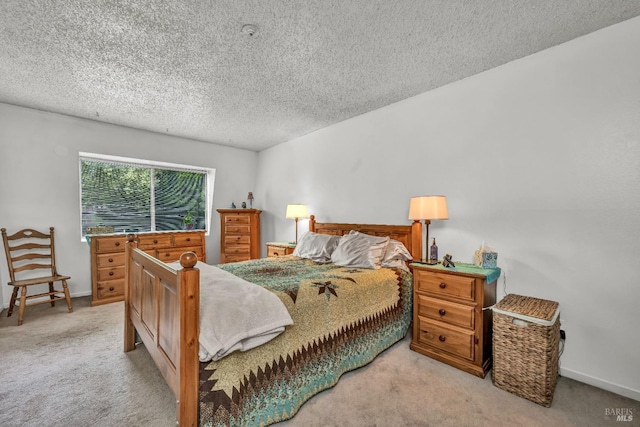 bedroom with baseboards, carpet flooring, and a textured ceiling