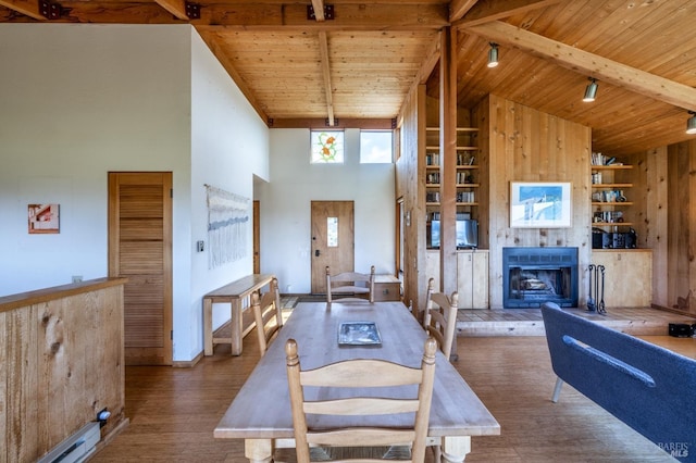 360 Grey Whale, The Sea Ranch, CA 95497 - dining space featuring built in features, beam ceiling, high vaulted ceiling, wooden ceiling, and a tiled fireplace