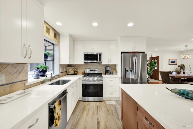 kitchen featuring recessed lighting, a sink, tasteful backsplash, and stainless steel appliances