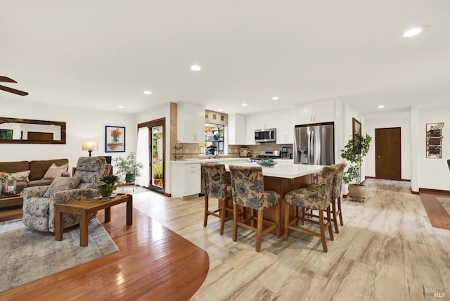 dining space with recessed lighting and light wood finished floors