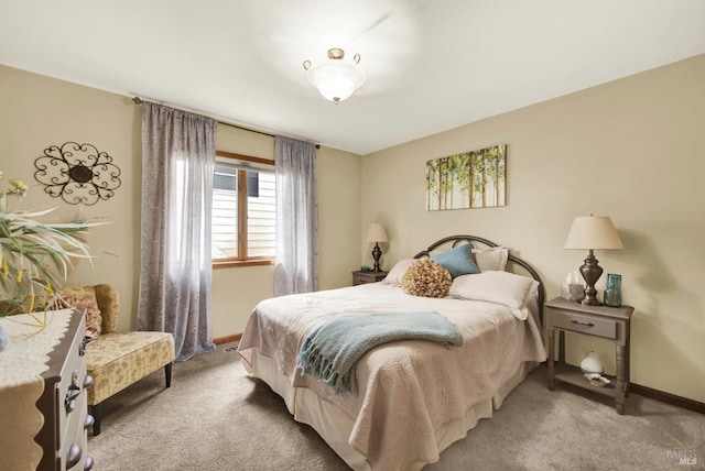 bedroom featuring baseboards and light colored carpet