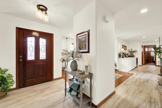 entryway featuring recessed lighting, baseboards, and light wood-style flooring