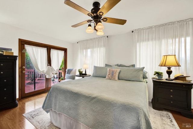 bedroom featuring access to outside, ceiling fan, and wood finished floors