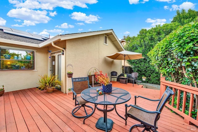 deck with outdoor dining space and visible vents
