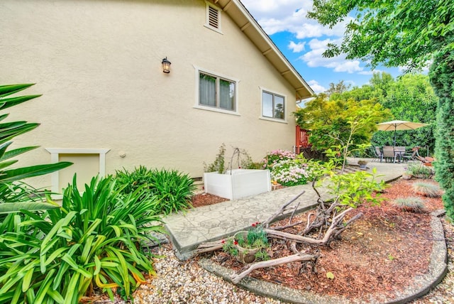 view of home's exterior featuring stucco siding and a patio area