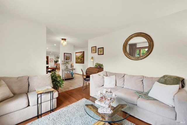 living area with recessed lighting and wood finished floors