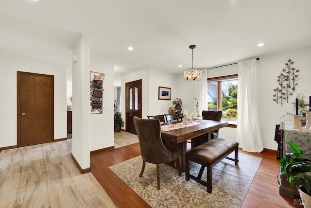 dining area featuring recessed lighting, baseboards, an inviting chandelier, and wood finished floors
