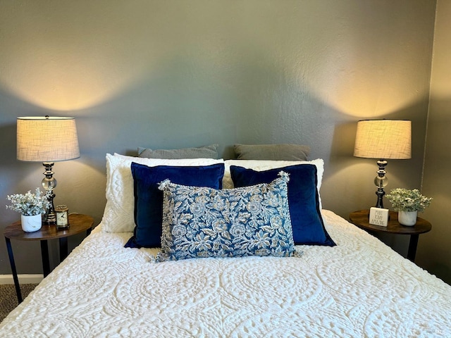 bedroom with baseboards and carpet flooring