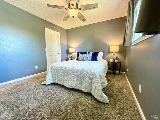 bedroom featuring baseboards, ceiling fan, carpet flooring, and a textured ceiling