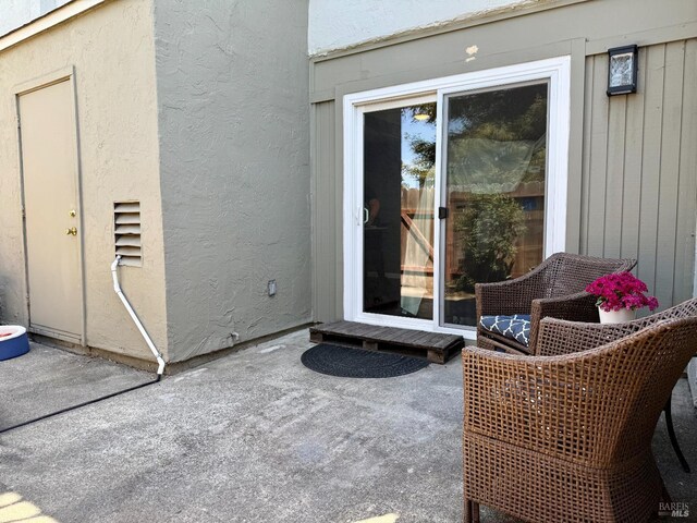 property entrance featuring a patio