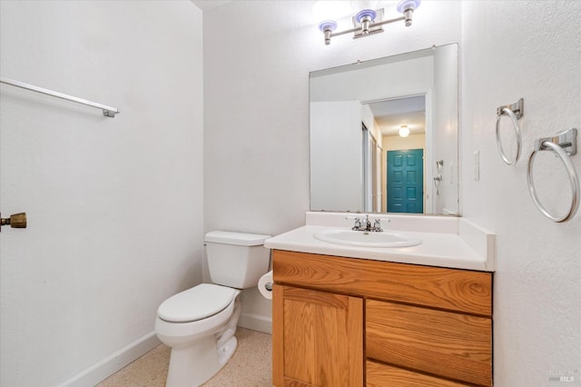 half bathroom featuring toilet, baseboards, speckled floor, and vanity