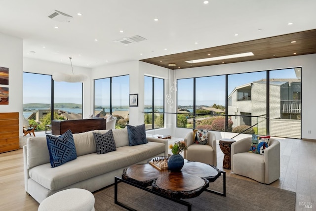 living room with recessed lighting, visible vents, and plenty of natural light