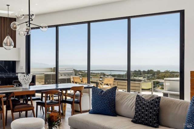 dining room featuring an inviting chandelier and a water view