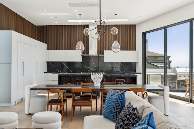 dining area with light wood-style floors, recessed lighting, a notable chandelier, and visible vents